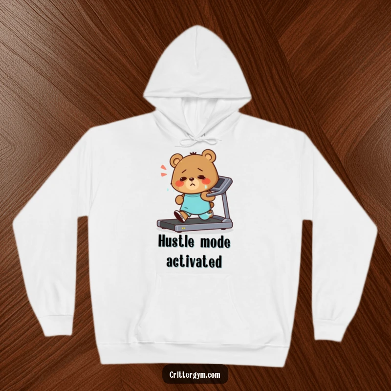Funny hoodie depicting a small, sweaty bear character intensely running on a treadmill with an unshakeable, determined smile, radiating workout motivation.