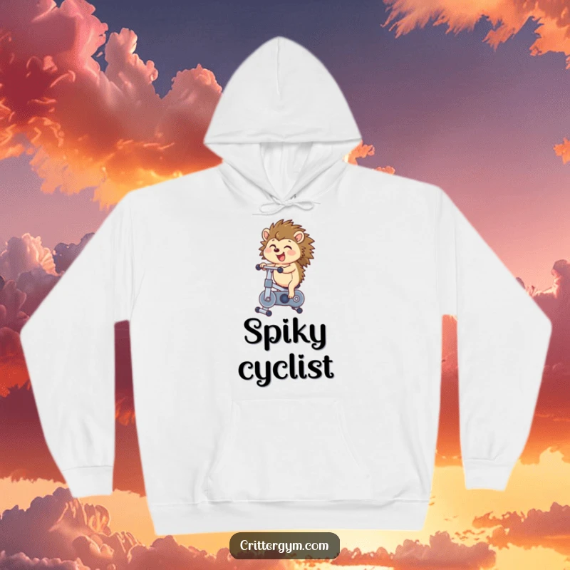 Funny hedgehog hoodie showcasing a happy hedgehog gleefully bouncing on a miniature exercise bike, symbolizing boundless energy and cute determination.