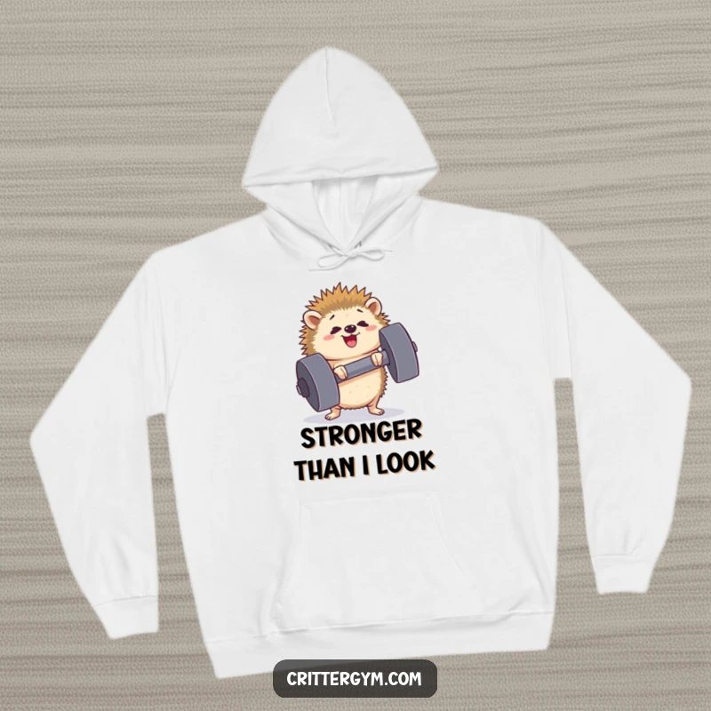 Funny determined hedgehog hoodie straining to lift a huge dumbbell, face showing effort and happiness, perfect for gym-goers, great for a funny gift.