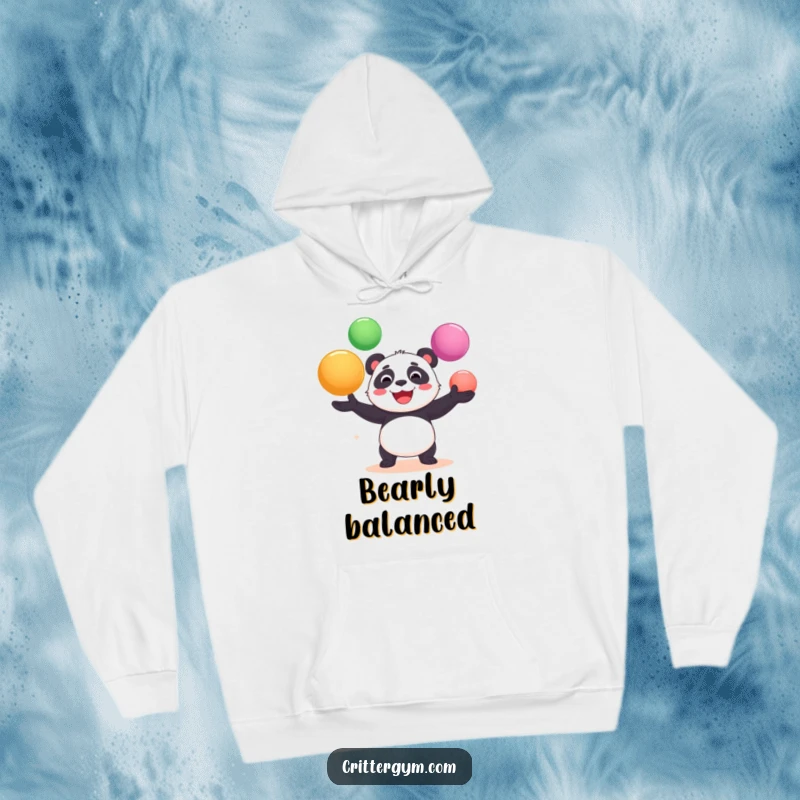 Funny hoodie displaying a cheerful panda bear in the act of gleefully juggling large yoga balls, a comical fitness scene.