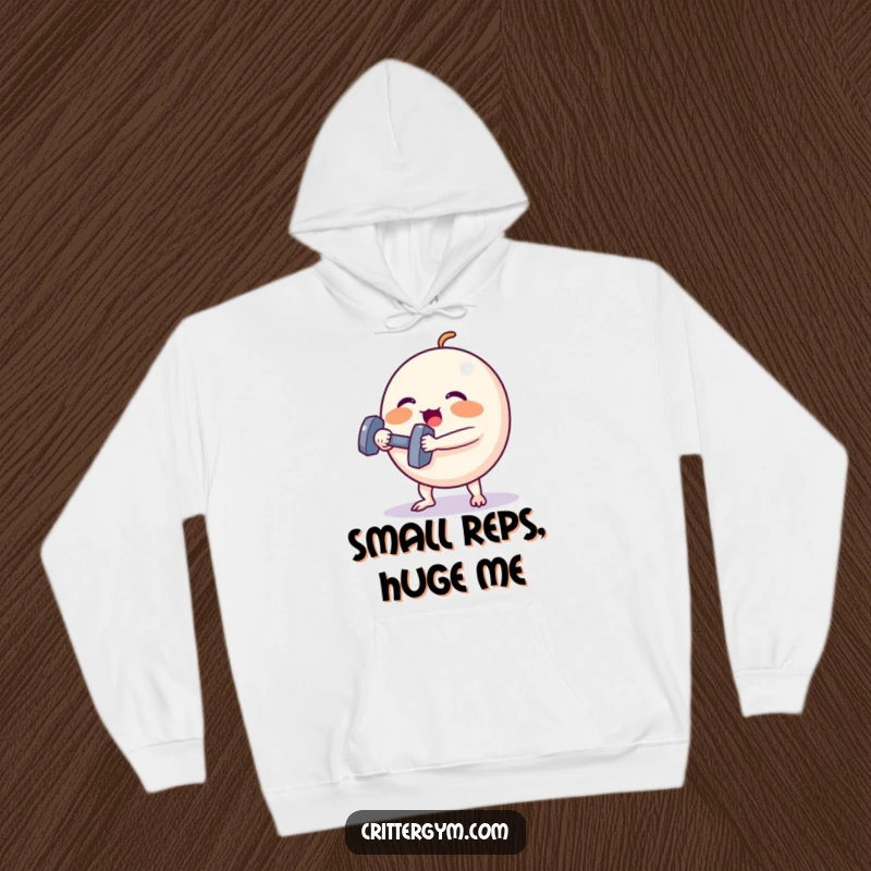 Funny Hoodie: A small, round creature strains with rosy cheeks, lifting a tiny dumbbell, a humorous depiction of gym effort.