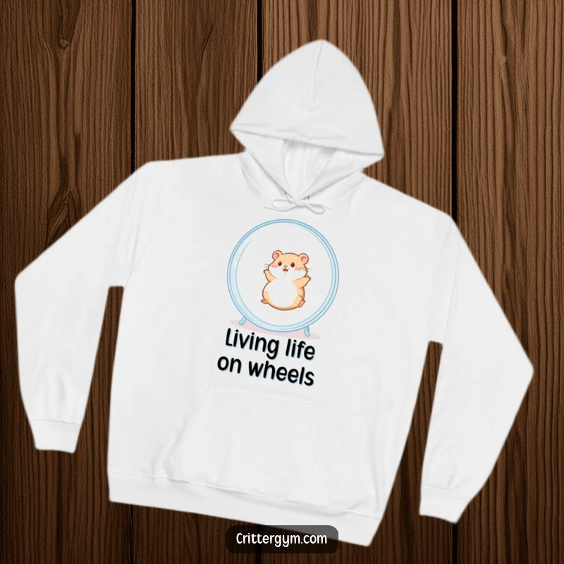 Funny hoodie depicting a chubby hamster exhilarated while rolling in a massive clear hamster wheel, perfect for cozy, humorous moments.