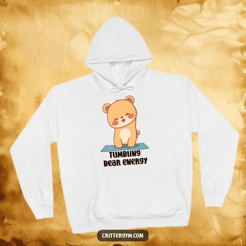 Funny hoodie featuring a giggling bear cub wobbling precariously while doing a yoga handstand on a mat.