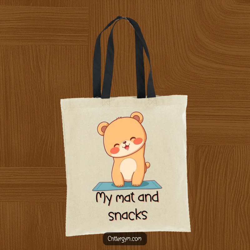 Funny tote bag illustration of a giggling bear cub attempting a yoga handstand on a mat, carrying essentials.